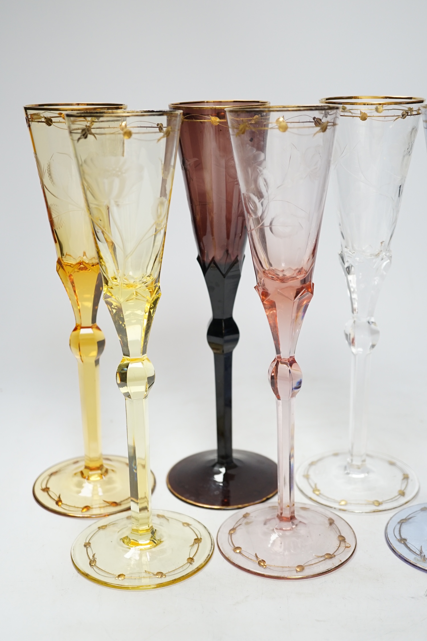 A set of six coloured Moser engraved and gilt enamelled, champagne flutes, 27cm high
